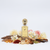 Fell Perfumes Najah sticla exactă din referință cu fundal alb și ingrediente în jurul bazei