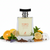 Frasco de perfume Toro Pour Homme Glacé de Maison Alhambra EDP, botella hexagonal transparente con líquido dorado-verde, texto coral TORO POUR HOMME GLACE y ciervo naranja, cuello cromado plateado y tapón en T gris cepillado, sobre fondo blanco, rodeado de cítricos, menta fresca, lavanda, hierbas aromáticas, maderas nobles, ámbar gris y almizcle.