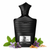 Frasco Venti Green Tweed EDP, botella ancha negro mate con textura acanalada horizontal en toda la superficie, hombros angulares anchos, cuello facetado angular negro mate corto, tapa estrella-flecha angular negro mate distintiva, etiqueta rectangular plateada con símbolo fleur-de-lis oscuro y texto Venti GREEN TWEED, rodeado de verbena de limón, iris, hoja de violeta, ámbar gris y sándalo.