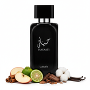 Frasco Hayaati de Lattafa EDP, botella redondeada negra brillante con caligrafía árabe حياتي plateada, texto blanco HAYAATI y script Lattafa, anillo plateado en cuello y tapa rectangular negra brillante, sobre fondo blanco, rodeado de manzana, bergamota, canela, maderas, almizcle y vainilla.